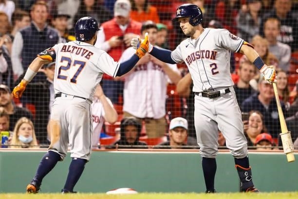 Jose Altuve reacts with Alex Bregman of the Houston Astros after hitting a solo home run in the sixth inning of a game against the Boston Red Sox at...