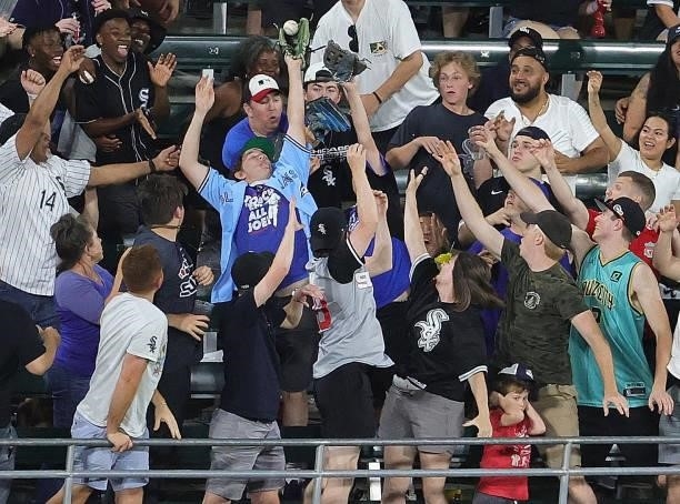 Fans try to catch a home run ball hit by Adam Engel of the Chicago White Sox in the 7th inning against the Toronto Blue Jays at Guaranteed Rate Field...