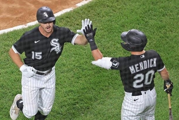 Adam Engel of the Chicago White Sox is congratulated by Danny Mendick after hitting his first home run of the season against the Toronto Blue Jays in...