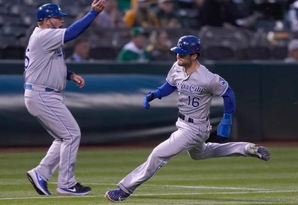 Andrew Benintendi of the Kansas City Royals rounds third base to score on an RBI double from Hunter Dozier against the Oakland Athletics in the top...