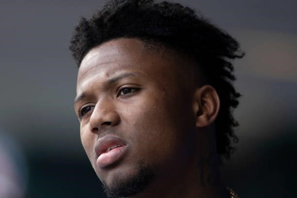 Ronald Acuna Jr. #13 of the Atlanta Braves looks on from the dugout against the Philadelphia Phillies at Citizens Bank Park on June 10, 2021 in...