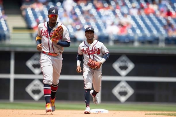 Ronald Acuna Jr. #13 and Ozzie Albies of the Atlanta Braves jog to the dugout against the Philadelphia Phillies at Citizens Bank Park on June 10,...