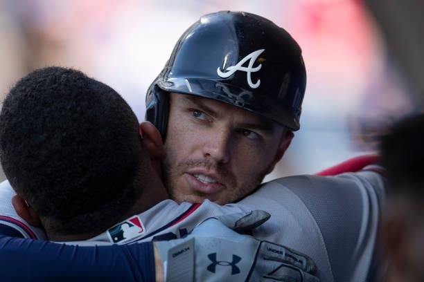 Freddie Freeman of the Atlanta Braves hugs Pablo Sandoval after hitting a solo home run in the top of the ninth inning against the Philadelphia...