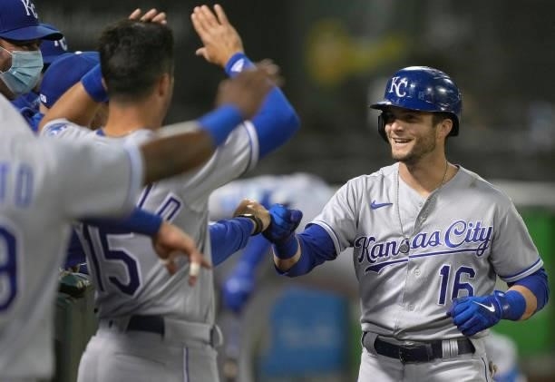 Andrew Benintendi of the Kansas City Royals is congratulated by teammates after he hit a solo home run against the Oakland Athletics in the top of...