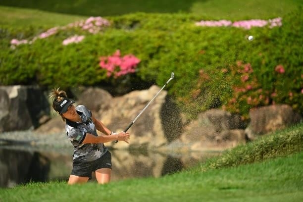 Asako Fujimoto of Japan hits out from a bunker on the 18th hole during the second round of the Ai Miyazato Suntory Ladies Open at Rokko Kokusai Golf...