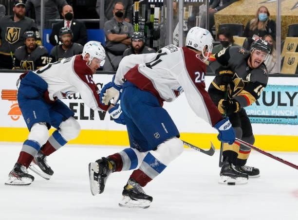 Reilly Smith of the Vegas Golden Knights passes against Valeri Nichushkin and Patrik Nemeth of the Colorado Avalanche in the second period in Game...
