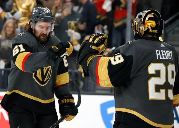 Mark Stone and Marc-Andre Fleury of the Vegas Golden Knights celebrate a third-period empty-net goal by Max Pacioretty against the Colorado Avalanche...