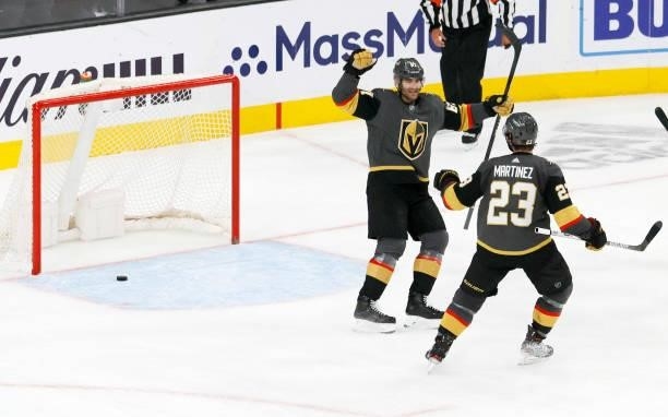 Max Pacioretty and Alec Martinez of the Vegas Golden Knights celebrate Pacioretty's third-period empty-net goal against the Colorado Avalanche in...