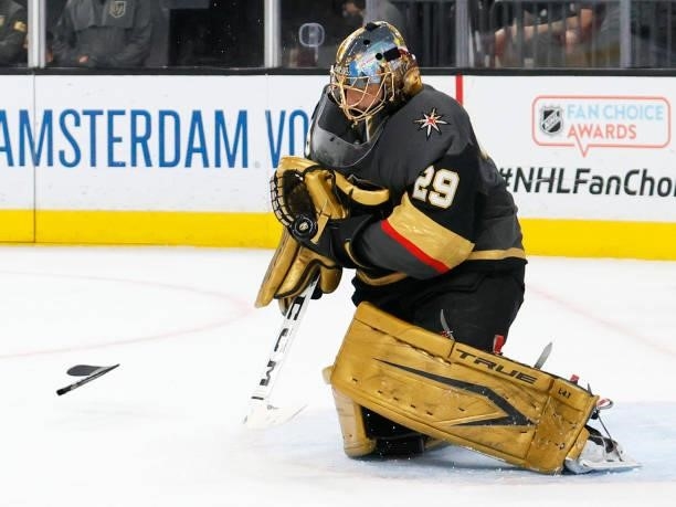 Part of a broken stick flies toward Marc-Andre Fleury of the Vegas Golden Knights as he makes a save against the Colorado Avalanche in the first...