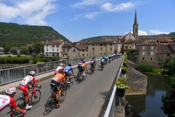 The Peloton passing through Bioule Village during the 45th La Route d'Occitanie - La Depeche Du Midi 2021, Stage 2 a 198,7km stage from...
