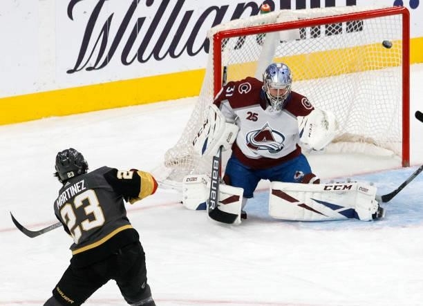 Philipp Grubauer of the Colorado Avalanche defends the net against Alec Martinez of the Vegas Golden Knights in the first period in Game Six of the...