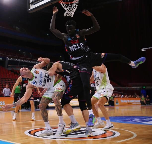 Jo Lual-Acuil of United and Mitch Creek of the Phoenix compete for the ball during game one of the NBL Semi-Final Series between Melbourne United and...