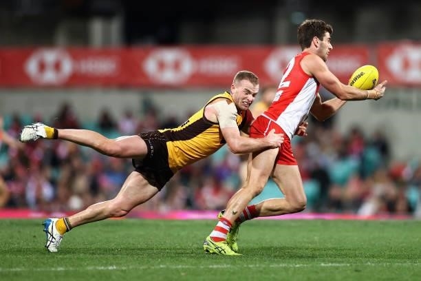 Tom Mitchell of the Hawks tackles Robbie Fox of the Swans during the round 13 AFL match between the Sydney Swans and the Hawthorn Hawks at Sydney...