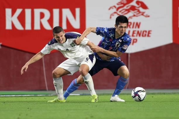 Naomichi Ueda of Japan and Dejan Joveljic of Serbia compete for the ball during the international friendly match between Japan and Serbia at Noevir...