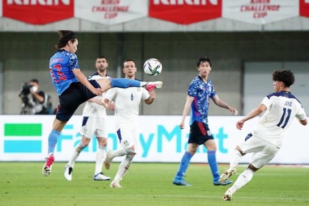 Kento Hashimoto of Japan and Nemanja Jovic of Serbia compete for the ball during the international friendly match between Japan and Serbia at Noevir...