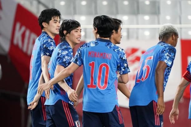Junya Ito of Japan celebrates scoring his side's first goal with his team mates during the international friendly match between Japan and Serbia at...