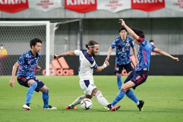 Nemanja Gudelj of Serbia competes for the ball against Genki Haraguchi and Hayao Kawabe of Japan during the international friendly match between...