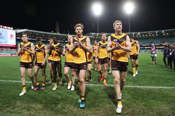Tim O'Brien and Ben McEvoy of the Hawks celebrate victory with team mates after the round 13 AFL match between the Sydney Swans and the Hawthorn...
