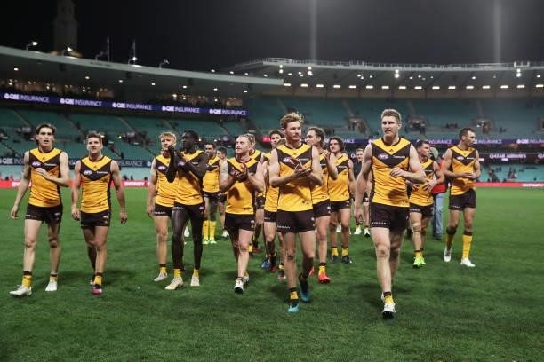Tim O'Brien and Ben McEvoy of the Hawks celebrate victory with team mates after the round 13 AFL match between the Sydney Swans and the Hawthorn...