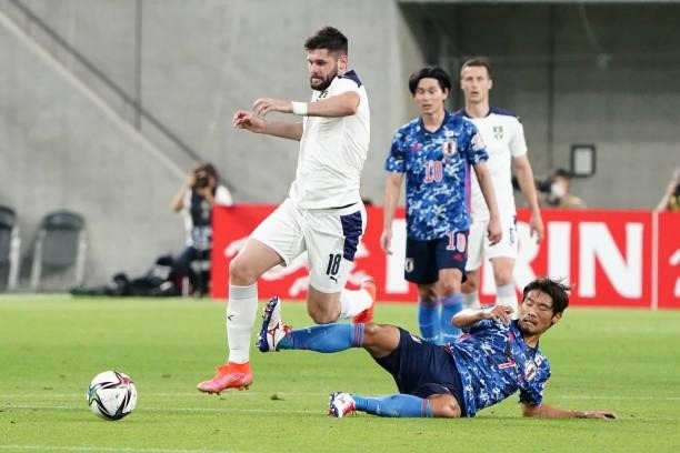 Milan Makaric of Serbia is tackled by Hidemasa Morita of Japan during the international friendly match between Japan and Serbia at Noevir Stadium...