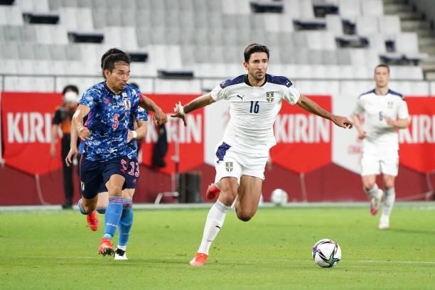 Marko Grujic of Serbia and Yuto Nagatomo of Japan compete for the ball during the international friendly match between Japan and Serbia at Noevir...