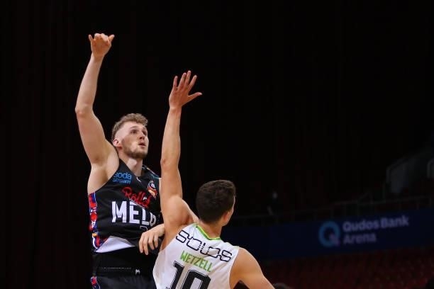 Jock Landale of United shoots under pressure from Yanni Wetzall of the Phoenix during game one of the NBL Semi-Final Series between Melbourne United...
