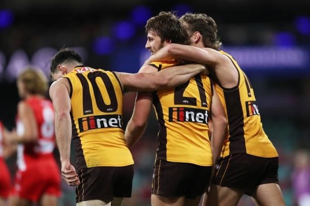 Tom Phillips of the Hawks celebrates with team mates after kicking a goal during the round 13 AFL match between the Sydney Swans and the Hawthorn...