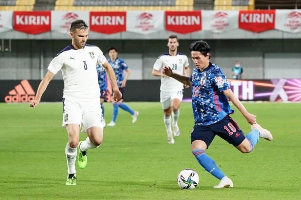 Takumi Minamino of Japan and Marko Petkovic of Serbia compete for the ball during the international friendly match between Japan and Serbia at Noevir...