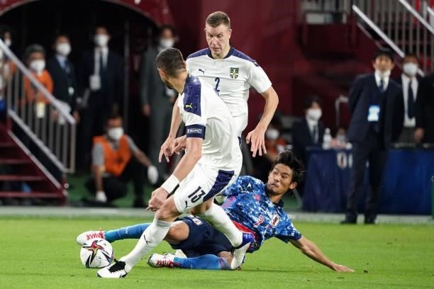 Strahinja Pavlovic of Serbia is tackled by Hidemasa Morita of Japan during the international friendly match between Japan and Serbia at Noevir...
