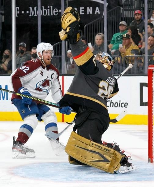 Marc-Andre Fleury of the Vegas Golden Knights makes a glove save in front of Gabriel Landeskog of the Colorado Avalanche in the third period in Game...