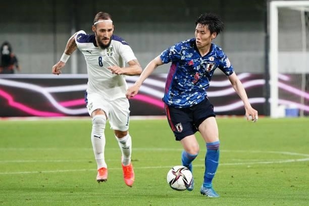 Daichi Kamada of Japan and Nemanja Gudelj of Serbia compete for the ball during the international friendly match between Japan and Serbia at Noevir...