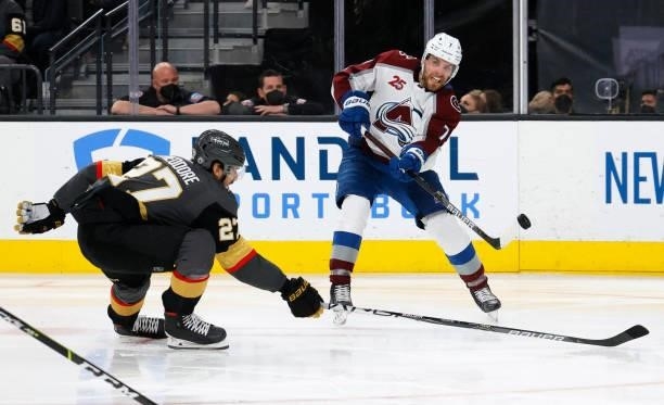Devon Toews of the Colorado Avalanche passes against Shea Theodore of the Vegas Golden Knights in the third period in Game Six of the Second Round of...