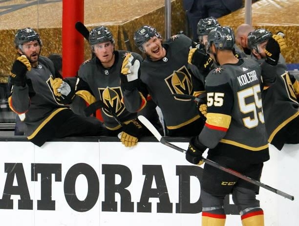 Keegan Kolesar of the Vegas Golden Knights celebrates with teammates Alec Martinez, Zach Whitecloud and Nick Holden on the bench after scoring a...