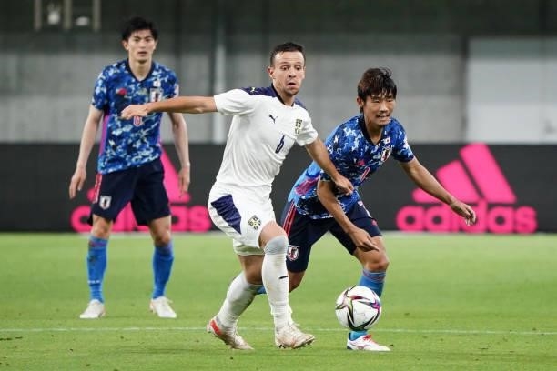 Nemanja Maksimovic of Serbia controls the ball under pressure of Hidemasa Morita of Japan during the international friendly match between Japan and...