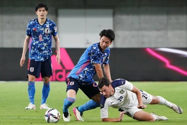 Hayao Kawabe of Japan and Milos Vulic of Serbia compete for the ball during the international friendly match between Japan and Serbia at Noevir...