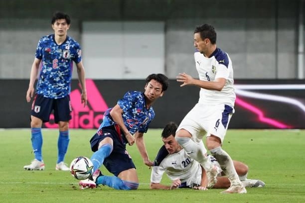 Hayao Kawabe of Japan competes for the ball against Milos Vulic and Nemanja Maksimovic of Serbia during the international friendly match between...