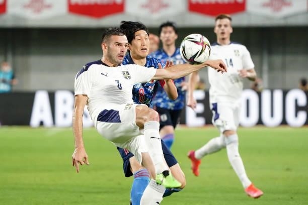 Marko Petkovic of Serbia and Genki Haraguchi of Japan compete for the ball during the international friendly match between Japan and Serbia at Noevir...