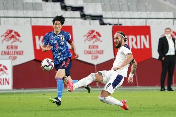 Nemanja Gudelj of Serbia and Genki Haraguchi of Japan compete for the ball during the international friendly match between Japan and Serbia at Noevir...