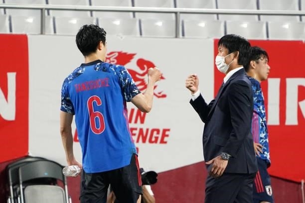 Head coach Hajime Moriyasu of Japan fist bumps with Shogo Taniguchi after their 1-0 victory in the international friendly match between Japan and...
