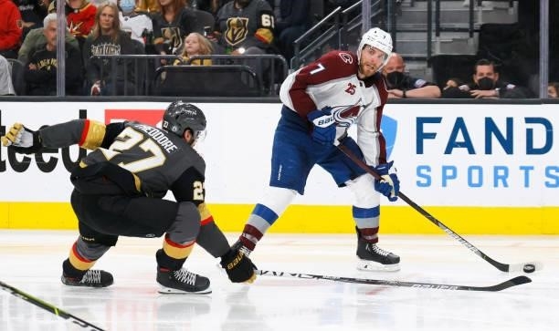 Devon Toews of the Colorado Avalanche passes against Shea Theodore of the Vegas Golden Knights in the third period in Game Six of the Second Round of...