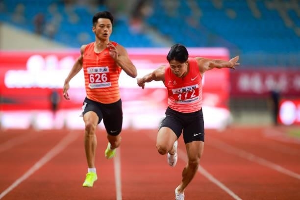 Su Bingtian of Guangdong and Xie Zhenye of Zhejiang compete in the Men's 100 Metres Final on day one of 2021 Chinese National Athletics Championships...