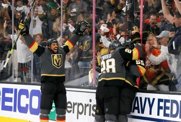 Ryan Reaves and William Carrier of the Vegas Golden Knights celebrate a second-period goal by Keegan Kolesar against the Colorado Avalanche in Game...