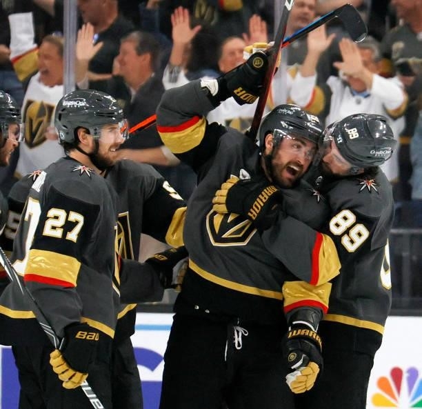 Shea Theodore, William Carrier and Alex Tuch of the Vegas Golden Knights celebrate Carrier's third-period goal against the Colorado Avalanche in Game...