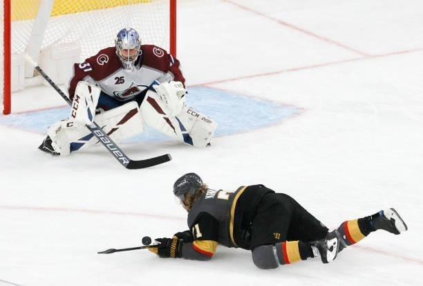 Philipp Grubauer of the Colorado Avalanche defends the net as William Karlsson of the Vegas Golden Knights is tripped in the third period in Game Six...