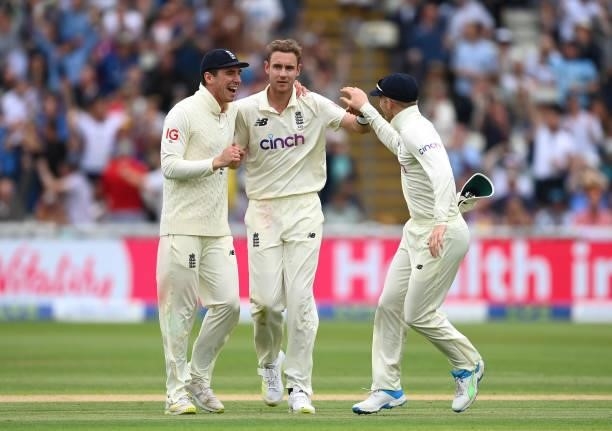 Stuart Broad of England celebrates the wicket of Devon Conway of New Zealand with Dan Lawrence and Sam Billings of England during day two of the...