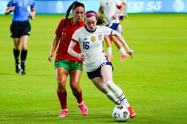 Rose Lavelle of United States dribbles the ball away from Fátima Pinto of Portugal during the second half the 2021 WNT Summer Series friendly between...