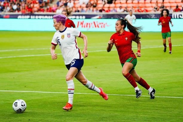Megan Rapinoe of United States dribbles away from Joana Marchão of Portugal during the first half of the 2021 WNT Summer Series friendly between the...