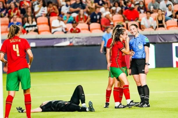 Joana Marchão of Portugal laughs with Referee Danielle Cheskythe as Inês Pereira of Portugal lays on the ground during the second half 2021 WNT...