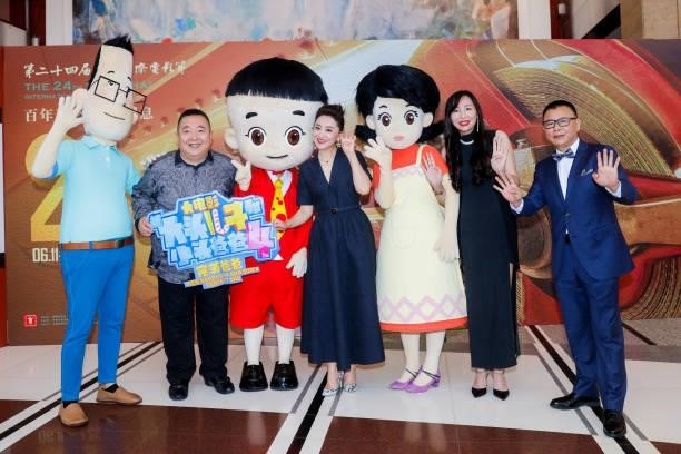 Television host Dong Hao poses with characters of the animated movie 'New Happy Dad and Son' during opening ceremony of the 24th Shanghai...