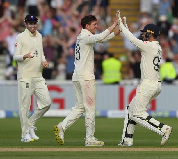 Dan Lawrence of England is congratulated by James Bracey and Dom Sibley after dismissing Will Young of New Zealand during the second day of the...